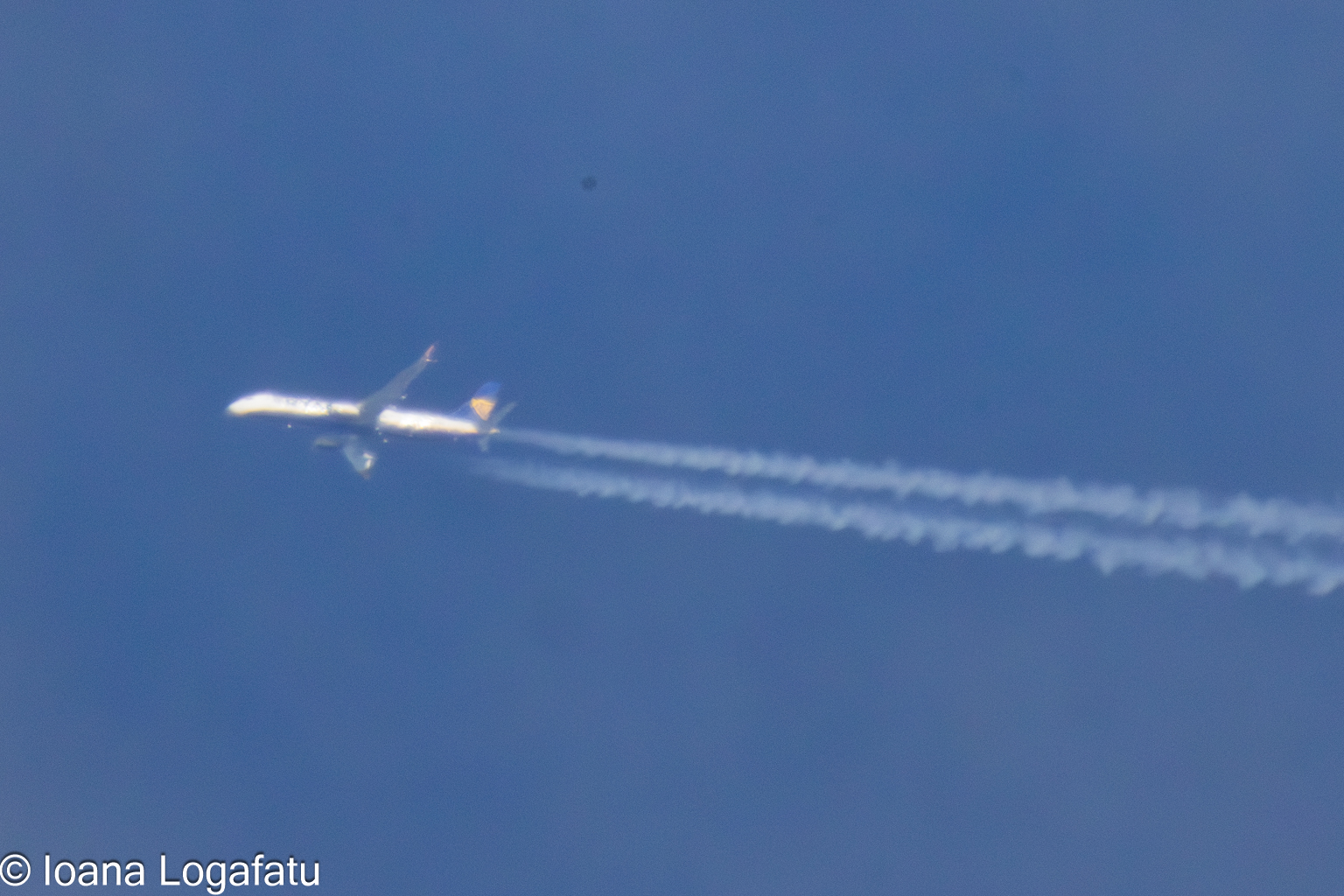 Aircraft gliding through a clear blue sky
